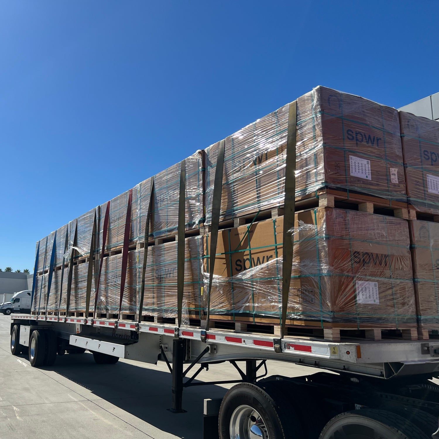 Flatbed truck loaded with palletized solar panels